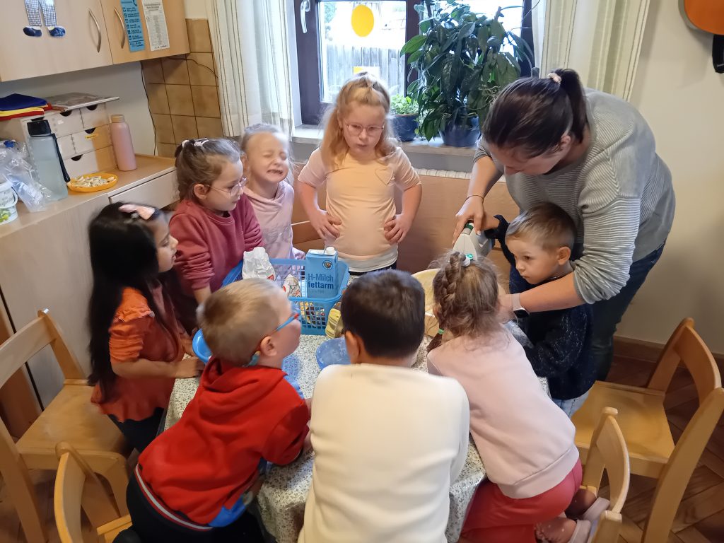 Die Katzenkinder backen gemeinsam mit Frau Grundler zum Erntedank einen Apfelkuchen.